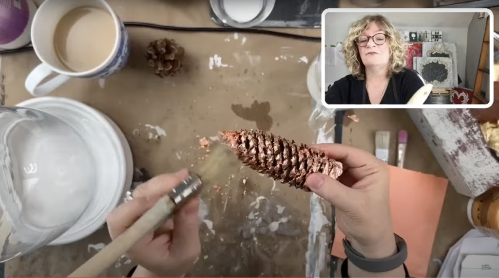 applying copper leaf to pine cones