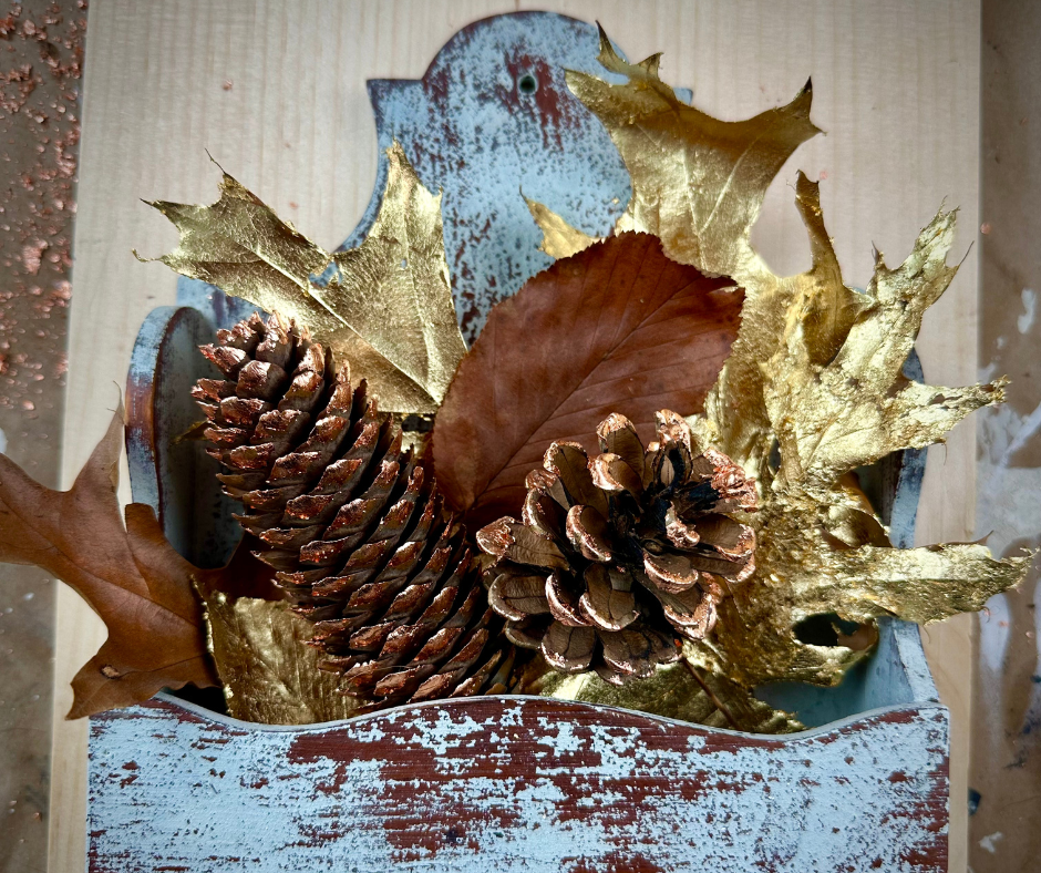 gilded pine cones and leaves